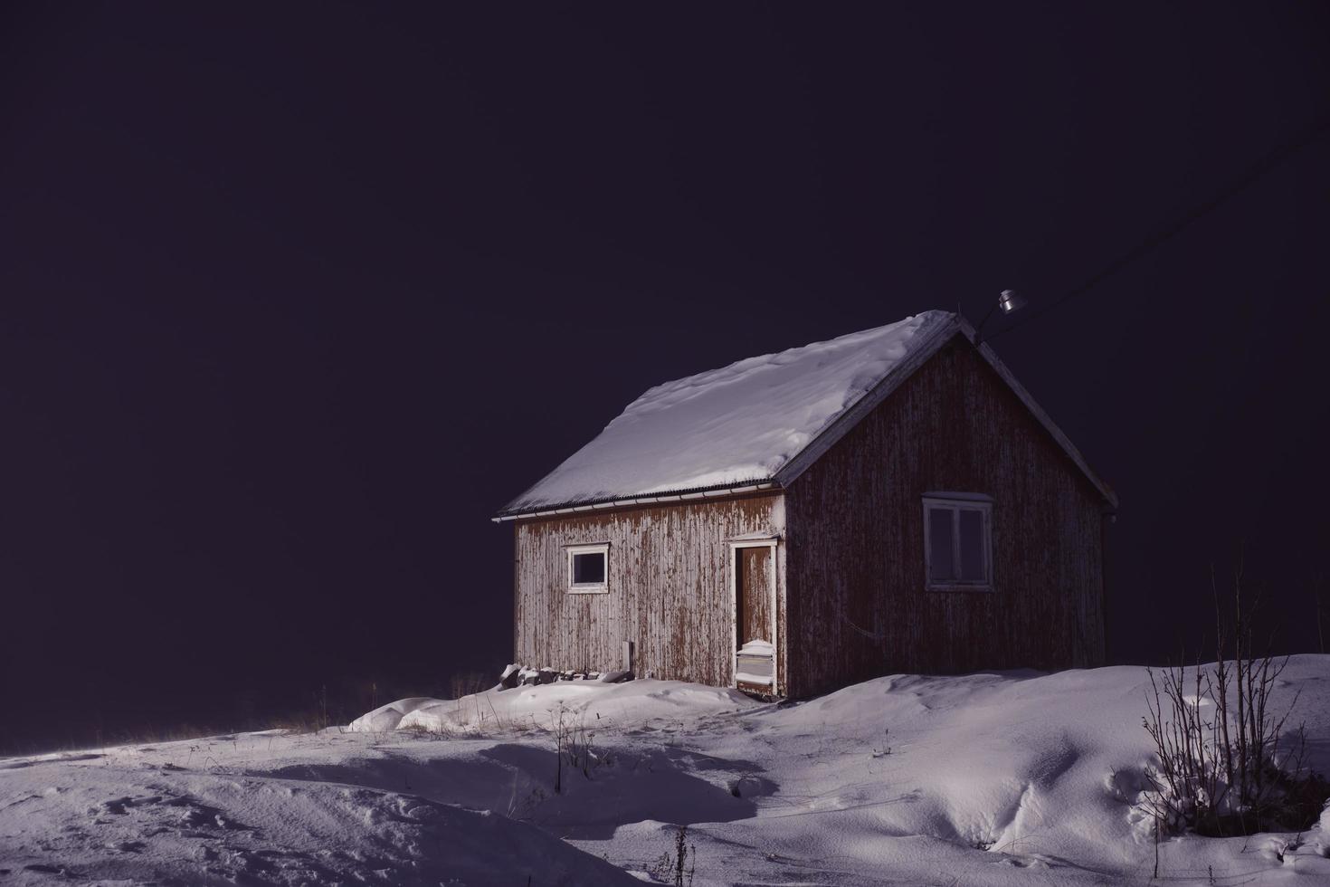 traditional norwegian fisherman s cabins covered with snow at night free photo