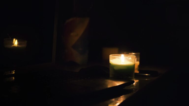 burning candles laptop and cellphone on the table candles in dark room no electricity in the house power outage in the city blackout energy crisis concept free video