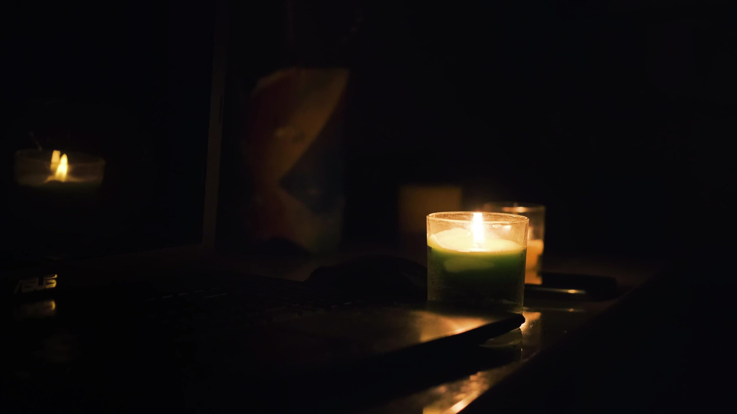 burning candles laptop and cellphone on the table candles in dark room no electricity in the house power outage in the city blackout energy crisis concept free video